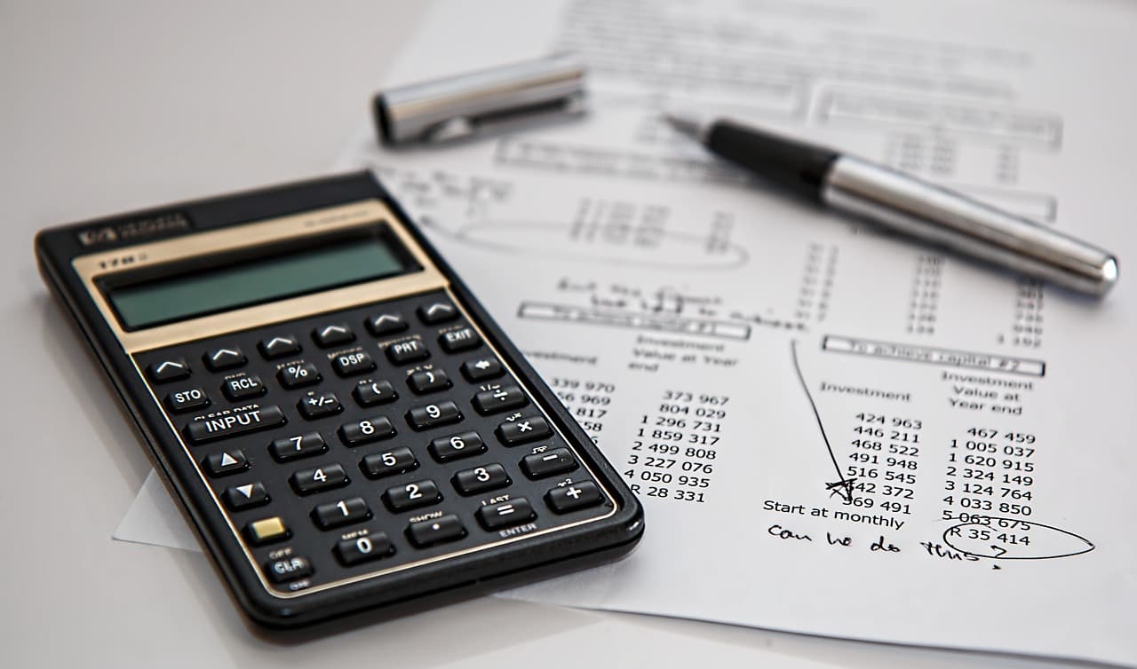 Financial documents and calculator representing quote comparison and analysis